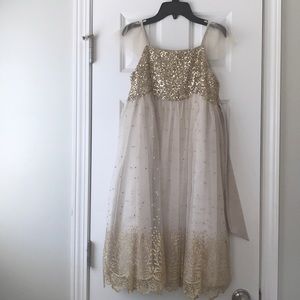Children’s fancy dress with gold and cream colors.